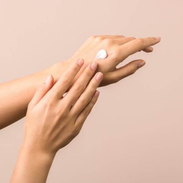 Hand cream being smoothed over the back of the hand